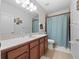 Clean bathroom with shower/tub combo, vanity with mirror, and tile flooring at 7351 Spring Mountain Ln, Yalaha, FL 34797