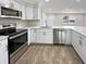 Updated kitchen with stainless steel appliances and white cabinets at 511 W Gardenia Dr, Orange City, FL 32763