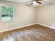 Bright bedroom with ceiling fan and large window at 511 W Gardenia Dr, Orange City, FL 32763