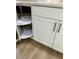 White kitchen cabinets with convenient corner shelving at 511 W Gardenia Dr, Orange City, FL 32763