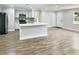 Modern kitchen with stainless steel appliances and a large island at 511 W Gardenia Dr, Orange City, FL 32763