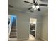 Bedroom with carpet, ceiling fan, and access to bathroom and stairs at 8282 Tavistock Lakes Blvd, Orlando, FL 32827