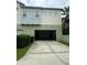 Attached garage with driveway and landscaping at 8282 Tavistock Lakes Blvd, Orlando, FL 32827