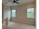 Spacious bedroom with carpeted floors and two windows at 8282 Tavistock Lakes Blvd, Orlando, FL 32827