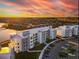 Aerial view of apartment buildings near a lake at sunset at 3161 Paradox Cir # 101, Kissimmee, FL 34746