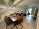 Open concept dining room with live-edge wood table and seating for six at 3161 Paradox Cir # 101, Kissimmee, FL 34746