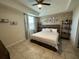 King-size bed in a bedroom with a brick feature wall at 3161 Paradox Cir # 101, Kissimmee, FL 34746