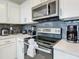 Modern kitchen with stainless steel appliances and white cabinets at 3161 Paradox Cir # 101, Kissimmee, FL 34746