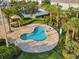 Small kidney shaped community pool with surrounding patio at 3161 Paradox Cir # 101, Kissimmee, FL 34746