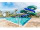 Resort-style pool with multiple slides and a large deck at 3161 Paradox Cir # 101, Kissimmee, FL 34746