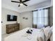 King sized bed in bright bedroom with large TV and ceiling fan at 3161 Paradox Cir # 101, Kissimmee, FL 34746