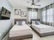 Two twin beds in a bedroom with window and TV at 3161 Paradox Cir # 101, Kissimmee, FL 34746