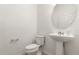 Clean bathroom with pedestal sink and toilet at 1909 Cayman Cove Cir, St Cloud, FL 34772