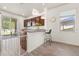 Modern kitchen with island, stainless steel appliances, and wood cabinets at 1909 Cayman Cove Cir, St Cloud, FL 34772