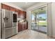 Modern kitchen with stainless steel appliances and wood cabinets, and backyard access at 1909 Cayman Cove Cir, St Cloud, FL 34772