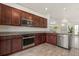 Modern kitchen with stainless steel appliances and wood cabinets at 1909 Cayman Cove Cir, St Cloud, FL 34772