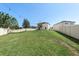 Large grassy backyard with a view of the house at 1909 Cayman Cove Cir, St Cloud, FL 34772