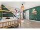 bedroom with green accent wall and wood bed at 1909 Cayman Cove Cir, St Cloud, FL 34772