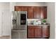 Modern kitchen with stainless steel appliances and wood cabinets at 1909 Cayman Cove Cir, St Cloud, FL 34772