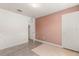 Bedroom with pink accent wall and access to bathroom at 1909 Cayman Cove Cir, St Cloud, FL 34772