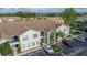 Complex of two story buildings with parking and tropical landscaping at 8850 Grand Palms Circle # B, Kissimmee, FL 34747