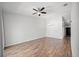 Spacious living room featuring hardwood floors and a ceiling fan at 8850 Grand Palms Circle # B, Kissimmee, FL 34747