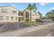 Condo building with multiple units and parking spaces in front at 8850 Grand Palms Circle # B, Kissimmee, FL 34747