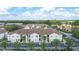 Complex of two story buildings with parking and tropical landscaping at 8850 Grand Palms Circle # B, Kissimmee, FL 34747