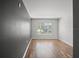 Spacious bedroom with large window, wood-look floors and a gray accent wall at 8850 Grand Palms Circle # B, Kissimmee, FL 34747