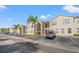 Condo building with multiple units and parking spaces in front at 8850 Grand Palms Circle # B, Kissimmee, FL 34747