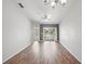 Bright living room featuring hardwood floors and access to balcony at 8850 Grand Palms Circle # B, Kissimmee, FL 34747