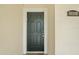 Dark green front door with a simple design, welcoming you to this lovely home at 8850 Grand Palms Circle # B, Kissimmee, FL 34747