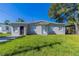 Ranch-style home with a well-maintained lawn at 1300 Mercy Dr, Orlando, FL 32808