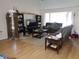 Spacious living room with hardwood floors and a large TV at 2618 Coventry Ln, Ocoee, FL 34761
