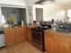 Kitchen features granite countertops, wood cabinets, and modern appliances at 2618 Coventry Ln, Ocoee, FL 34761