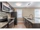 Modern kitchen with granite countertops and stainless steel appliances at 112 S Moss St, Leesburg, FL 34748