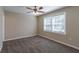 Spacious bedroom with ceiling fan and large window at 112 S Moss St, Leesburg, FL 34748