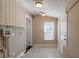 Laundry room with built-in shelving and exterior access at 112 S Moss St, Leesburg, FL 34748