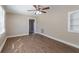 Spacious living room featuring hardwood floors and ceiling fan at 112 S Moss St, Leesburg, FL 34748