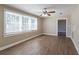 Sunlit living room with hardwood floors and large windows at 112 S Moss St, Leesburg, FL 34748
