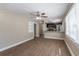 Living room with wood-look floors, ceiling fan, and built-in shelving at 112 S Moss St, Leesburg, FL 34748