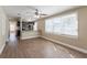 Spacious living room with wood-look floors and ceiling fan at 112 S Moss St, Leesburg, FL 34748