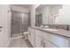 Modern bathroom with double vanity, large shower, and grey tile floors at 2816 Simile St, Kissimmee, FL 34746