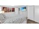 Bedroom with queen bed, wood furniture, and large TV at 5080 Seminole Ave, Winter Park, FL 32792
