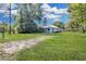 Spacious backyard with a long driveway at 5080 Seminole Ave, Winter Park, FL 32792