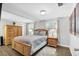 Main bedroom with wood furniture, wood floors and large windows at 5080 Seminole Ave, Winter Park, FL 32792
