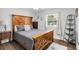 Bedroom with wood bed frame and dark wood night stand at 5080 Seminole Ave, Winter Park, FL 32792