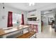 Bright dining area with table, bench and red stools, open to kitchen at 5080 Seminole Ave, Winter Park, FL 32792