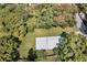 Aerial view showing a house nestled among lush trees at 5080 Seminole Ave, Winter Park, FL 32792