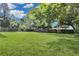 Large backyard with green grass and mature trees at 5080 Seminole Ave, Winter Park, FL 32792
